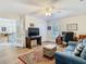 Inviting living room featuring a comfortable blue sofa, decorative rug, and adjacent office space at 5253 Sandra Dr, Weeki Wachee, FL 34607