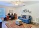 Comfortable living area with a cozy blue sofa, ottoman, and a functional desk area for work at 5253 Sandra Dr, Weeki Wachee, FL 34607