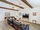 Spacious living room with wooden beams, hardwood floors, and a comfortable leather sofa at 5253 Sandra Dr, Weeki Wachee, FL 34607