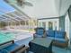 The covered patio features wicker seating and a ceiling fan for comfortable outdoor living at 5253 Sandra Dr, Weeki Wachee, FL 34607
