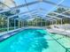 Sparkling pool enclosed by a white frame with a screen for outdoor entertainment at 5253 Sandra Dr, Weeki Wachee, FL 34607