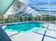 A pristine pool is enclosed by a bright white frame, offering privacy and outdoor enjoyment at 5253 Sandra Dr, Weeki Wachee, FL 34607