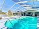 Inviting screened-in pool area with ample space for seating and entertaining in a beautiful yard at 5253 Sandra Dr, Weeki Wachee, FL 34607