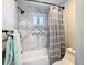 Modern shower with white marble tiling, shower curtain, and matte black hardware at 5253 Sandra Dr, Weeki Wachee, FL 34607