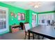 Bright sun room with green walls, tile floors, ceiling fan, and multiple windows for natural light at 5253 Sandra Dr, Weeki Wachee, FL 34607