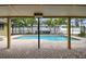 Inviting screened-in pool area surrounded by lush tropical landscaping and a privacy fence at 5303 12Th Avenue W Dr, Bradenton, FL 34209