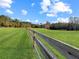 Expansive green pasture enclosed by a wooden fence at 5655 Wo Griffin Rd, Plant City, FL 33567