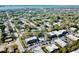 Aerial view of a community with condos, parking, pool, and abundant trees at 700 Lyndhurst St # 1024, Dunedin, FL 34698