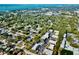 Expansive aerial view showcasing the neighborhood's layout, lush greenery, and nearby coastline at 700 Lyndhurst St # 1024, Dunedin, FL 34698