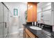 Bathroom featuring granite countertop, and glass enclosed shower stall at 700 Lyndhurst St # 1024, Dunedin, FL 34698