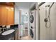 Bathroom with granite countertop and combo washer/dryer at 700 Lyndhurst St # 1024, Dunedin, FL 34698