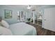 Bedroom features lots of light from windows and mirrored closet doors at 700 Lyndhurst St # 1024, Dunedin, FL 34698