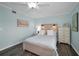 Cozy bedroom with wood-look flooring, beach-themed decor and a ceiling fan at 700 Lyndhurst St # 1024, Dunedin, FL 34698