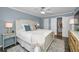 Bedroom featuring blue accent wall, stylish furnishings and ceiling fan at 700 Lyndhurst St # 1024, Dunedin, FL 34698