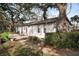 Charming home featuring a private outdoor patio, lush greenery, and a well-manicured lawn at 700 Lyndhurst St # 1024, Dunedin, FL 34698