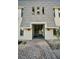 A brick walkway leads up to a condo building entrance with stairs at 700 Lyndhurst St # 1024, Dunedin, FL 34698
