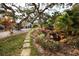 Lush landscaping, walking path, and serene water feature enhance the outdoor living experience at 700 Lyndhurst St # 1024, Dunedin, FL 34698
