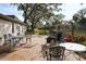 Private outdoor patio featuring brick pavers, lush landscaping, and outdoor seating at 700 Lyndhurst St # 1024, Dunedin, FL 34698
