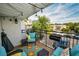 Inviting patio with comfortable seating, a vibrant rug, string lights, and a view of the surrounding landscape at 700 Lyndhurst St # 1024, Dunedin, FL 34698