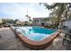 Community pool surrounded by brick pavers with ample seating in a beautiful residential area at 700 Lyndhurst St # 1024, Dunedin, FL 34698