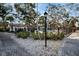 Community pool area with lush landscaping and an iron fence at 700 Lyndhurst St # 1024, Dunedin, FL 34698