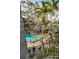 Community pool area featuring a refreshing pool, lounge chairs, and lush landscaping at 700 Lyndhurst St # 1024, Dunedin, FL 34698