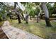 Picturesque walkway with stone pavers and lush landscaping creates a serene outdoor environment at 700 Lyndhurst St # 1024, Dunedin, FL 34698