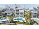 Aerial view showcasing a modern home with a pool, lush landscaping, and waterfront access at 8505 Blind Pass Dr, Treasure Island, FL 33706