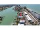 Aerial view shows the coastal neighborhood with canal access, mature landscaping, and neighborhood amenities at 8505 Blind Pass Dr, Treasure Island, FL 33706