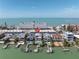Aerial view of waterfront home with private docks and pool, highlighted with a red arrow at 8505 Blind Pass Dr, Treasure Island, FL 33706