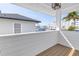Balcony view showcasing neighborhood buildings and blue skies with a modern white railing at 8505 Blind Pass Dr, Treasure Island, FL 33706