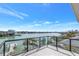 Balcony boasting stunning water views, clear railings, and a glimpse of lush greenery at 8505 Blind Pass Dr, Treasure Island, FL 33706