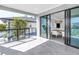 Balcony features tile flooring, glass railings, and sliding glass doors leading to the dining area at 8505 Blind Pass Dr, Treasure Island, FL 33706