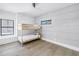 Bright bedroom with wooden bunk beds, light hardwood flooring, and a modern window design at 8505 Blind Pass Dr, Treasure Island, FL 33706