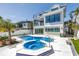 Modern home featuring a pool, spa, and a multi-level balcony, perfect for outdoor living and entertaining at 8505 Blind Pass Dr, Treasure Island, FL 33706