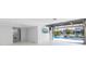 Spacious garage opens to pool with disappearing doors, features TV, and ample open space at 8505 Blind Pass Dr, Treasure Island, FL 33706