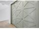 Hallway featuring a unique sage colored sliding barn door with geometric design at 8505 Blind Pass Dr, Treasure Island, FL 33706