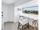 Bright home office nook with built-in desk overlooking a scenic waterfront view at 8505 Blind Pass Dr, Treasure Island, FL 33706