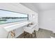 Bright home office nook with built-in desk overlooking a scenic waterfront view at 8505 Blind Pass Dr, Treasure Island, FL 33706
