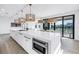 Gourmet kitchen with white quartz countertops, center island, pendant lighting and stainless steel appliances at 8505 Blind Pass Dr, Treasure Island, FL 33706