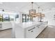 Modern, eat-in kitchen featuring a center island, pendant lighting, and an open concept living space at 8505 Blind Pass Dr, Treasure Island, FL 33706