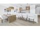 Kitchen features a long center island with white quartz countertop and bar seating at 8505 Blind Pass Dr, Treasure Island, FL 33706