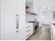 Bright kitchen with white cabinets, subway tile backsplash, stainless steel appliances, and wood floors at 8505 Blind Pass Dr, Treasure Island, FL 33706