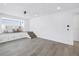 Spacious living room with elevated platform, large window, and clean white paneled walls at 8505 Blind Pass Dr, Treasure Island, FL 33706