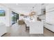 Open concept living room with water views, a modern kitchen with a large island, and stylish decor at 8505 Blind Pass Dr, Treasure Island, FL 33706