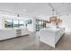 Bright, open-concept living space flows seamlessly to the sleek kitchen and waterfront views beyond at 8505 Blind Pass Dr, Treasure Island, FL 33706