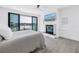 Main bedroom featuring a fireplace, balcony access, and waterfront views at 8505 Blind Pass Dr, Treasure Island, FL 33706
