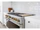 Professional grade oven with stainless steel finish, brass knobs, and white countertop at 8505 Blind Pass Dr, Treasure Island, FL 33706