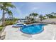 Backyard pool and spa offer waterfront views, surrounded by lush landscaping and outdoor seating at 8505 Blind Pass Dr, Treasure Island, FL 33706