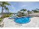 Beautiful pool and spa combination, surrounded by lush landscaping and a waterfront view with a private dock at 8505 Blind Pass Dr, Treasure Island, FL 33706